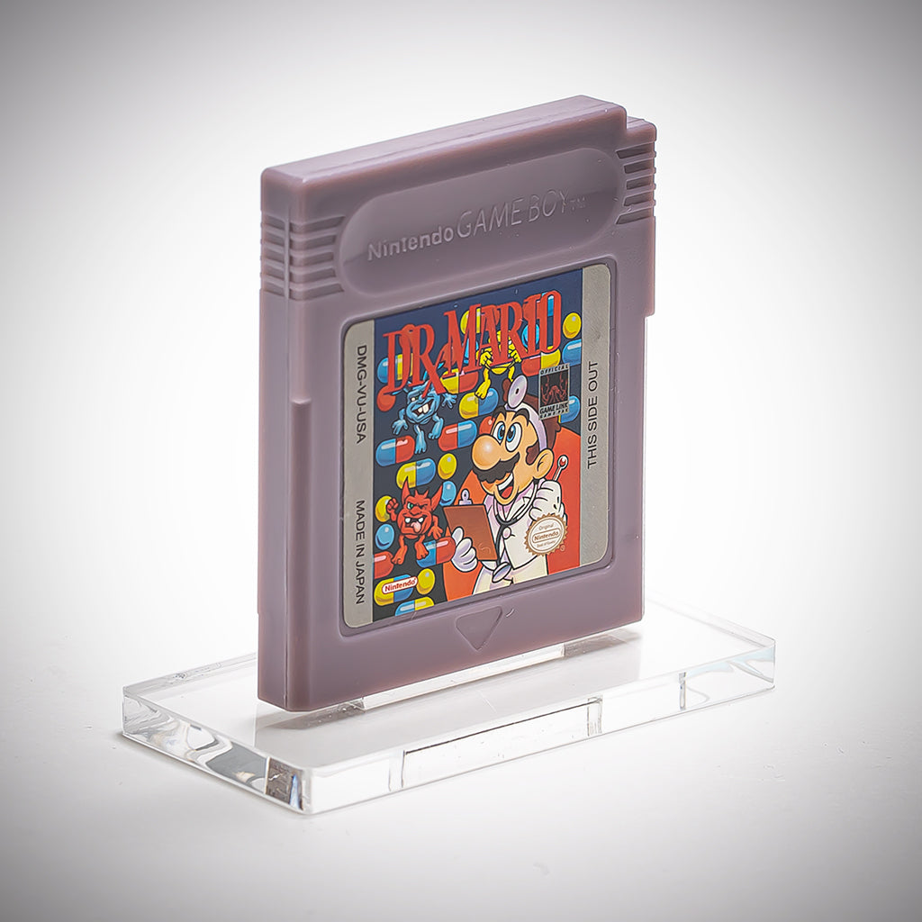 Nintendo Game Boy cartridge of Dr. Mario on a clear stand with a white background