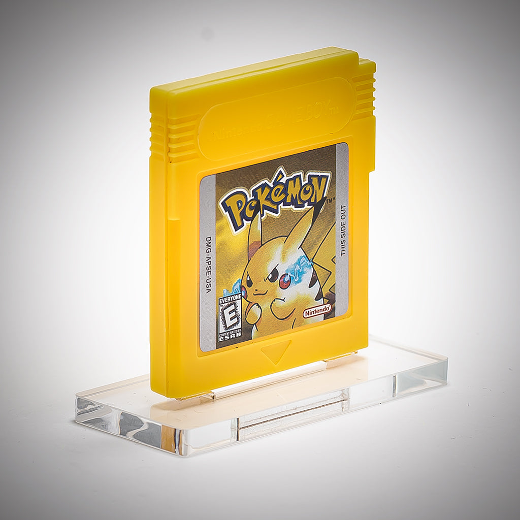 Yellow Game Boy cartridge with Pikachu on a clear stand against a gray background