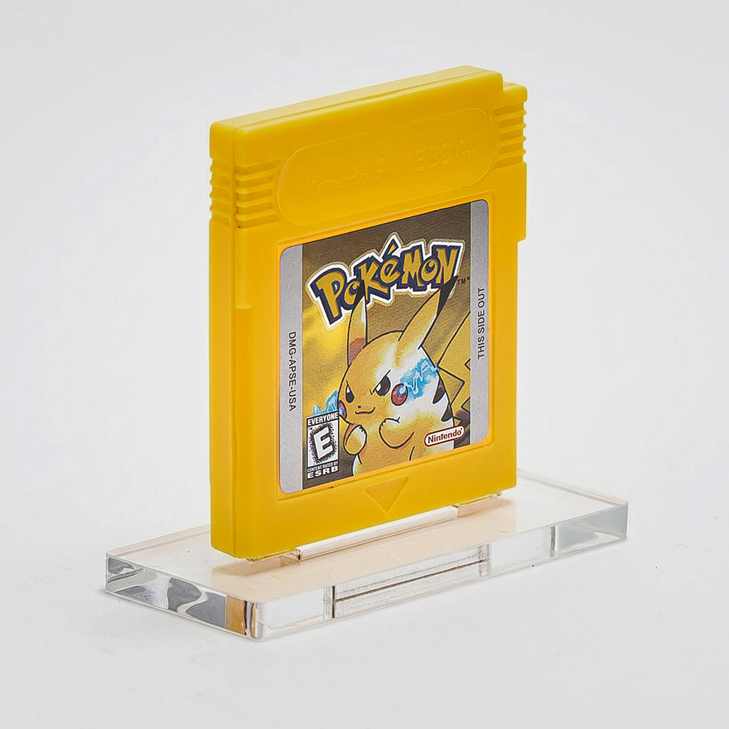 Yellow Game Boy cartridge with Pikachu on a clear stand against a gray background